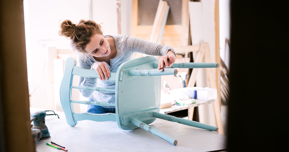 young woman upcycling chair