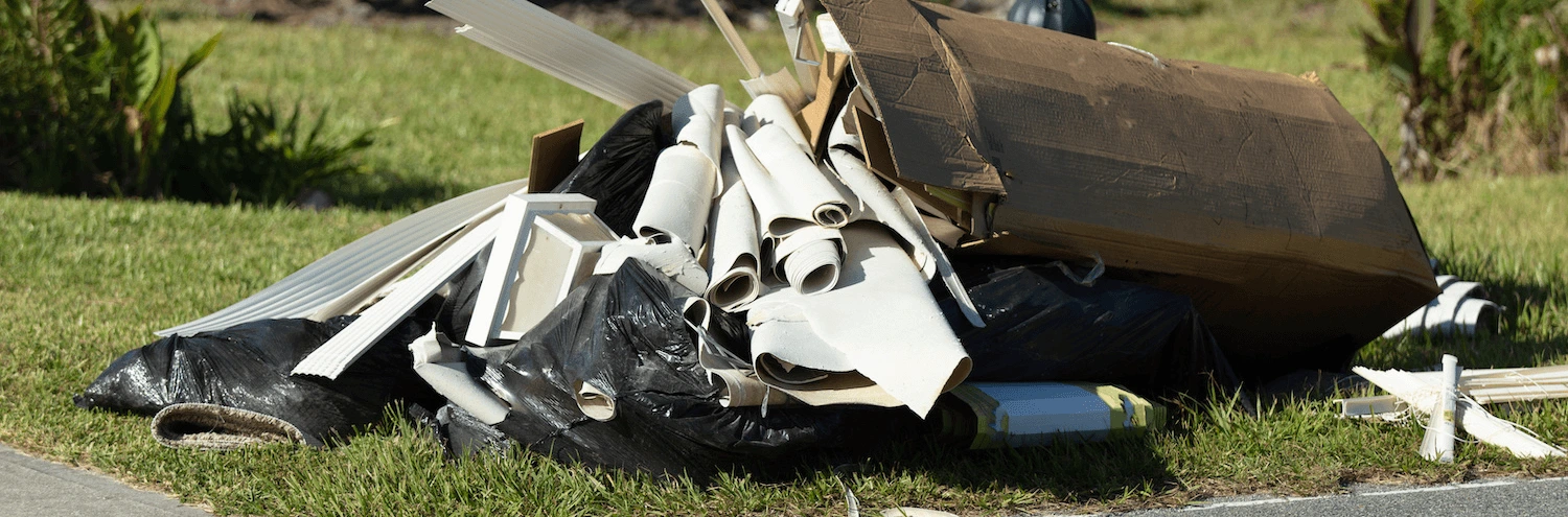 Household items and bags piled on a nature strip for a council clean-up