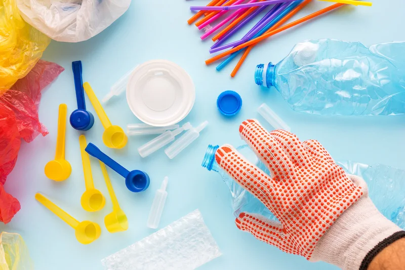 Worker sorting plastic garbage for recycling