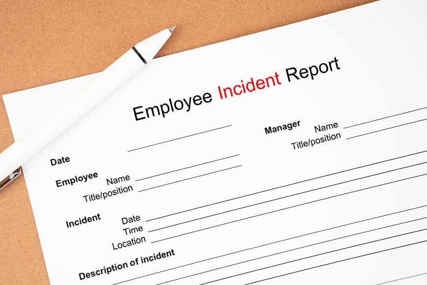 an employee incident report form and white pen