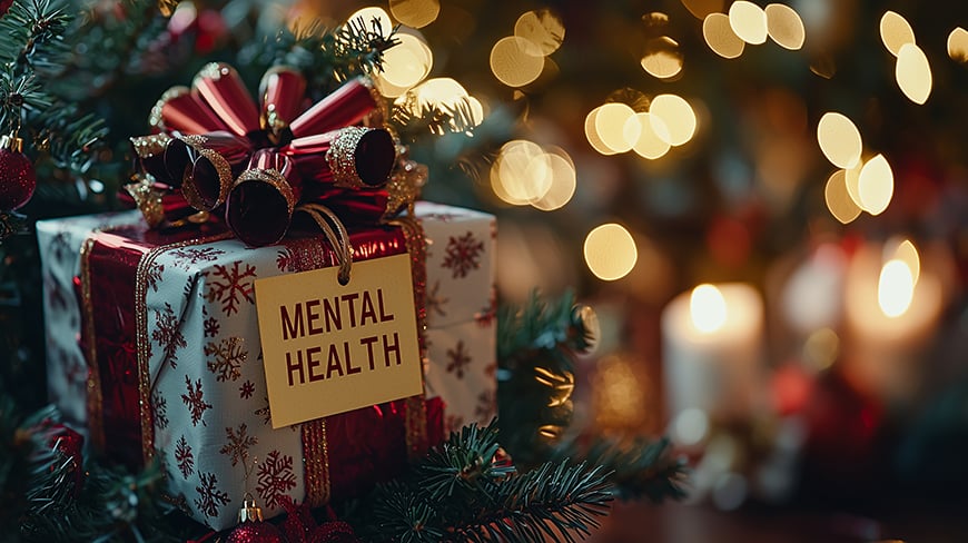gift box next to a christmas tree with the label “mental health”