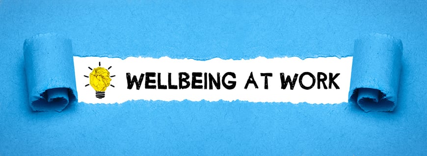 wellbeing at work written on a blue background with a yellow lightbulb