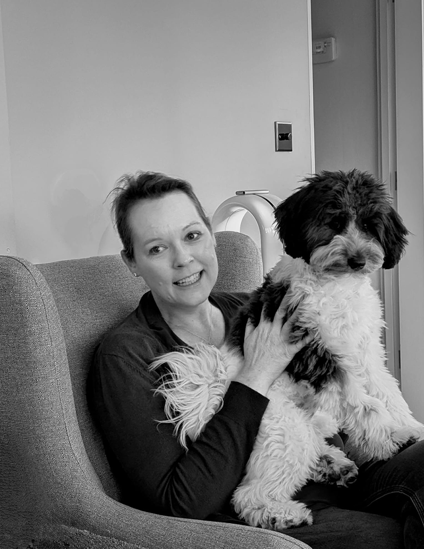 bella sitting on meggan looking very proud of herself