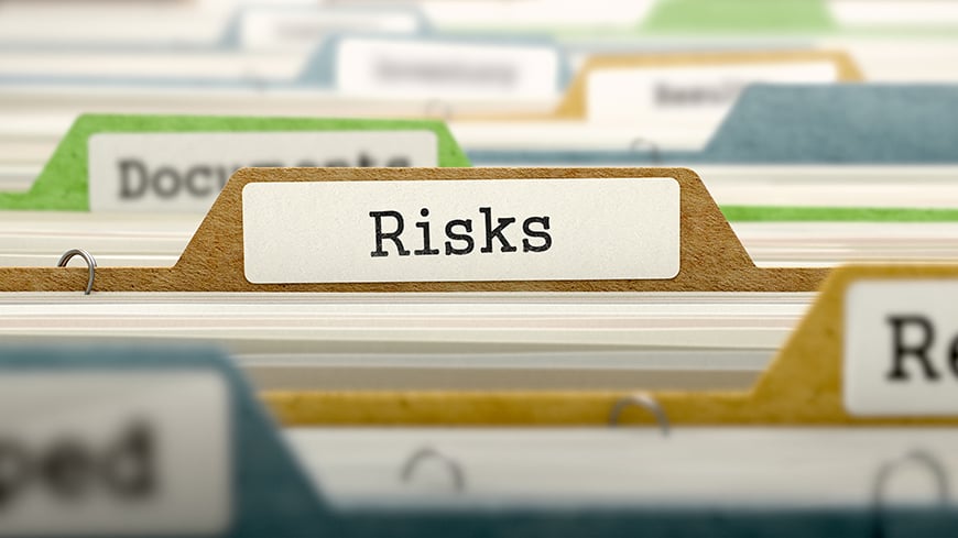 risks written on a file label in multicolour card index