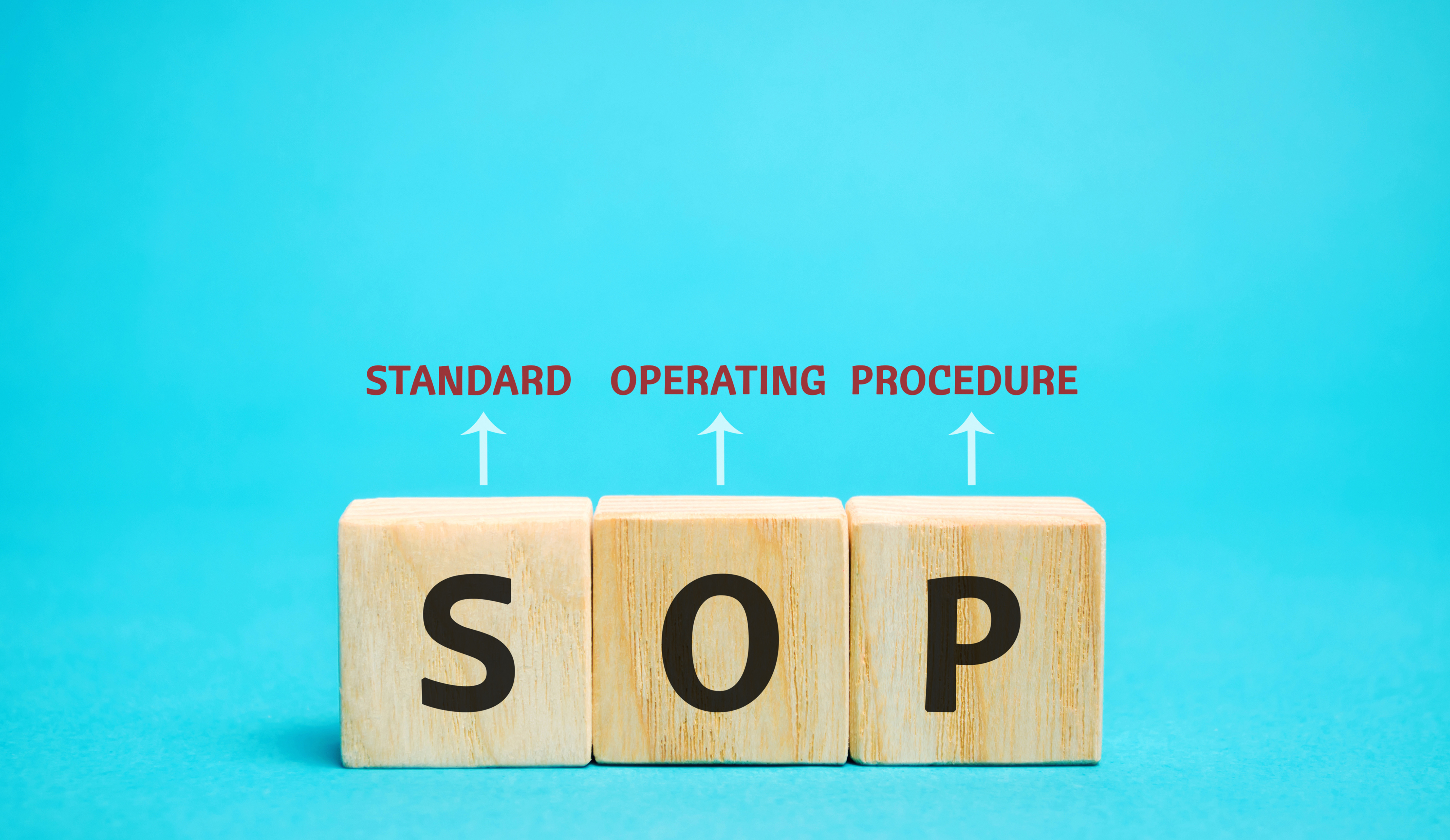 Wooden blocks with the word SOP (Standard operating procedure)