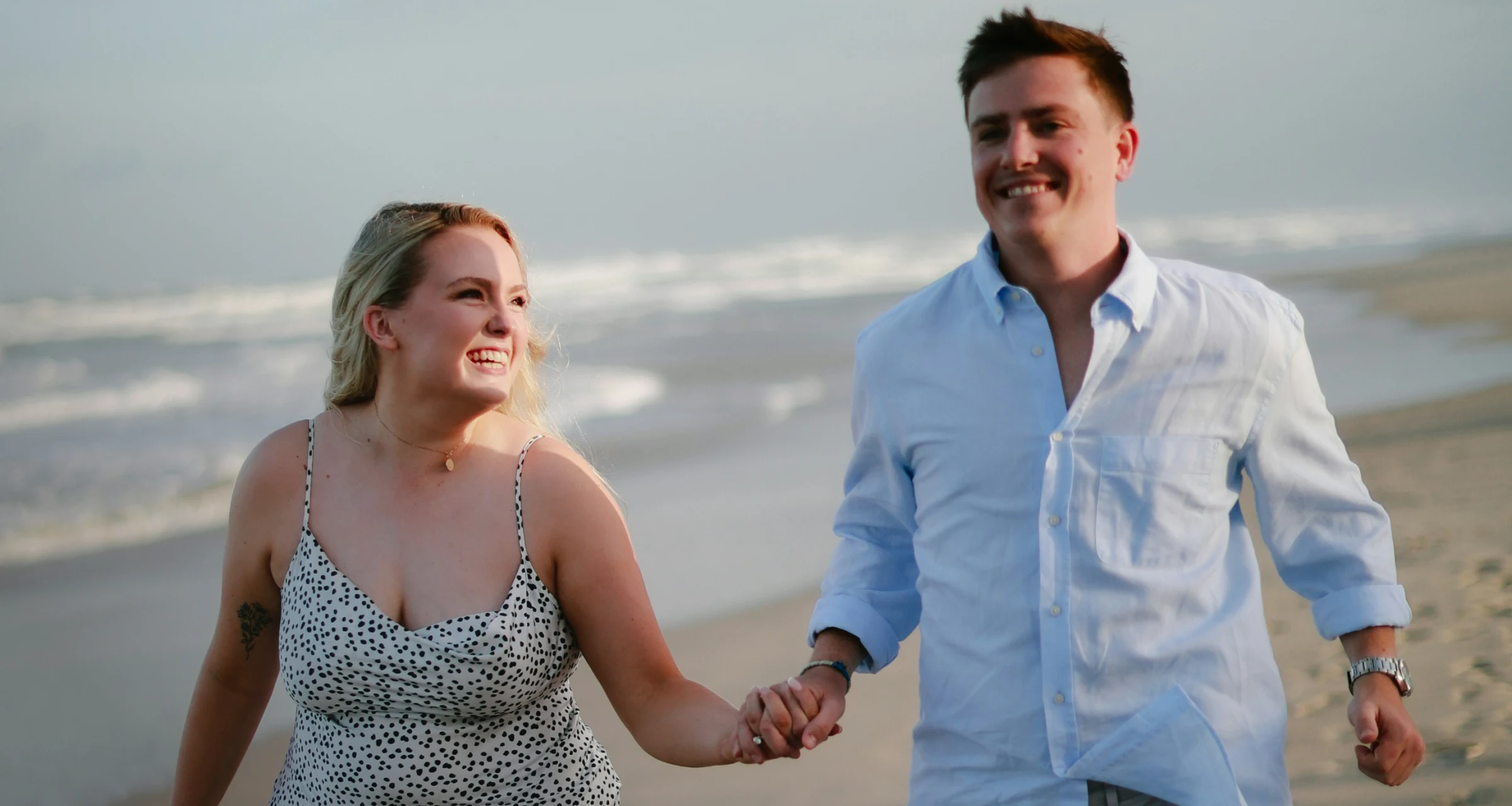 Couple walking on the beach, representing taking the next step in personalized health care