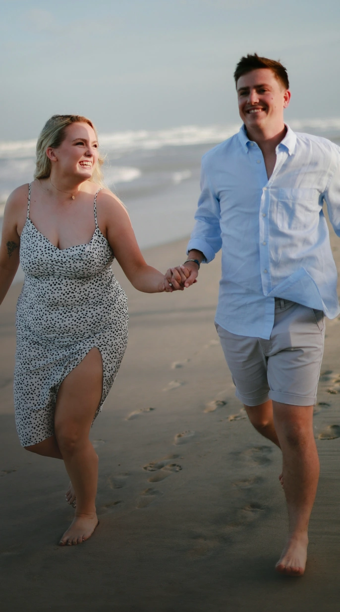 Couple walking on the beach, representing taking the next step in personalized health care