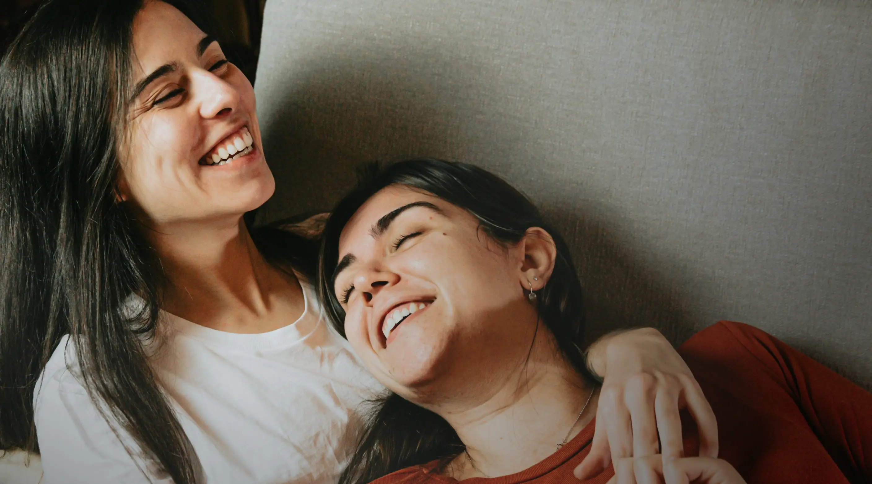 Two women smiling together, representing personalized hormone replacement therapy care