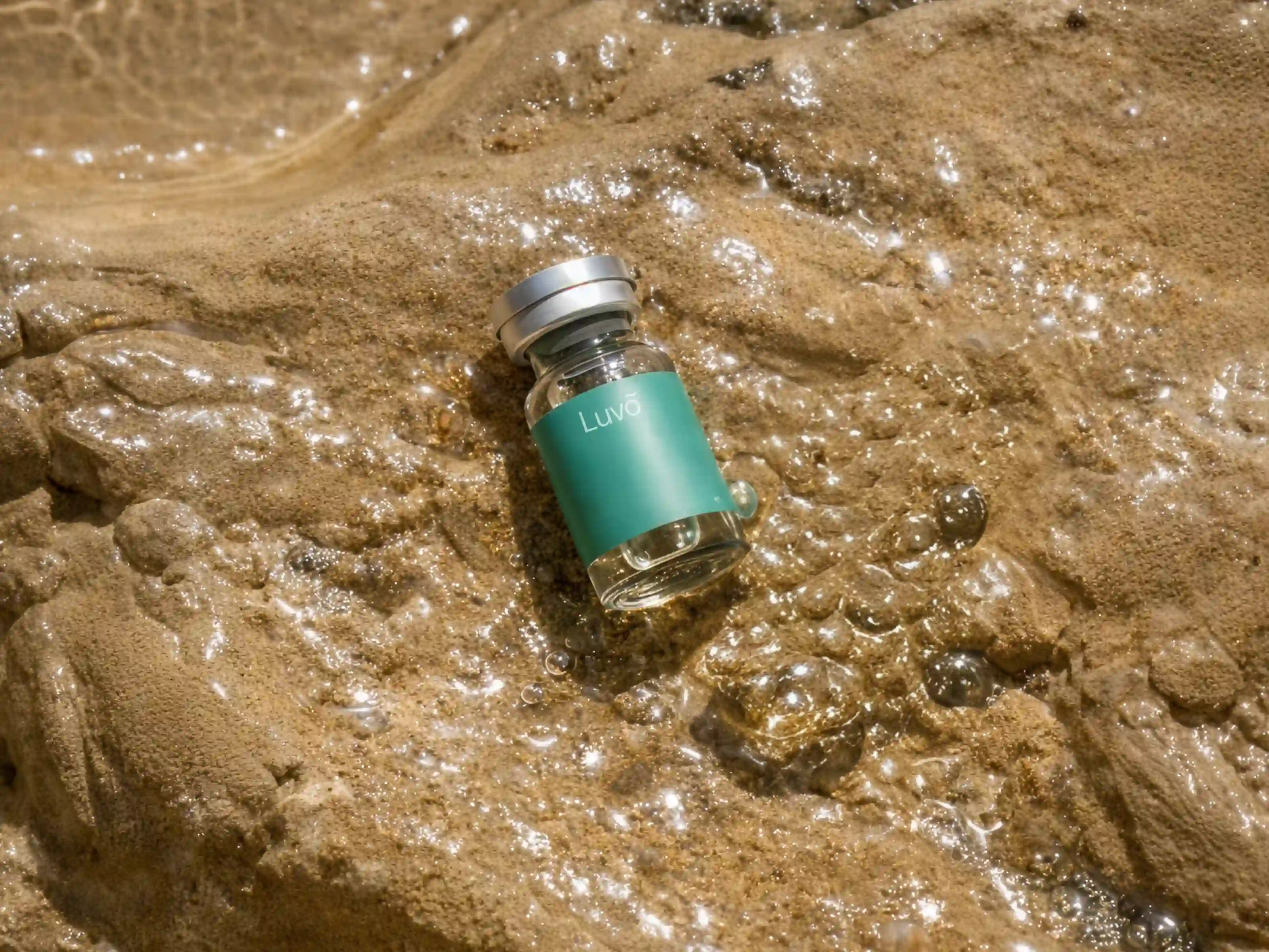 Illustrative tirzepatide injection vial on a sandy surface