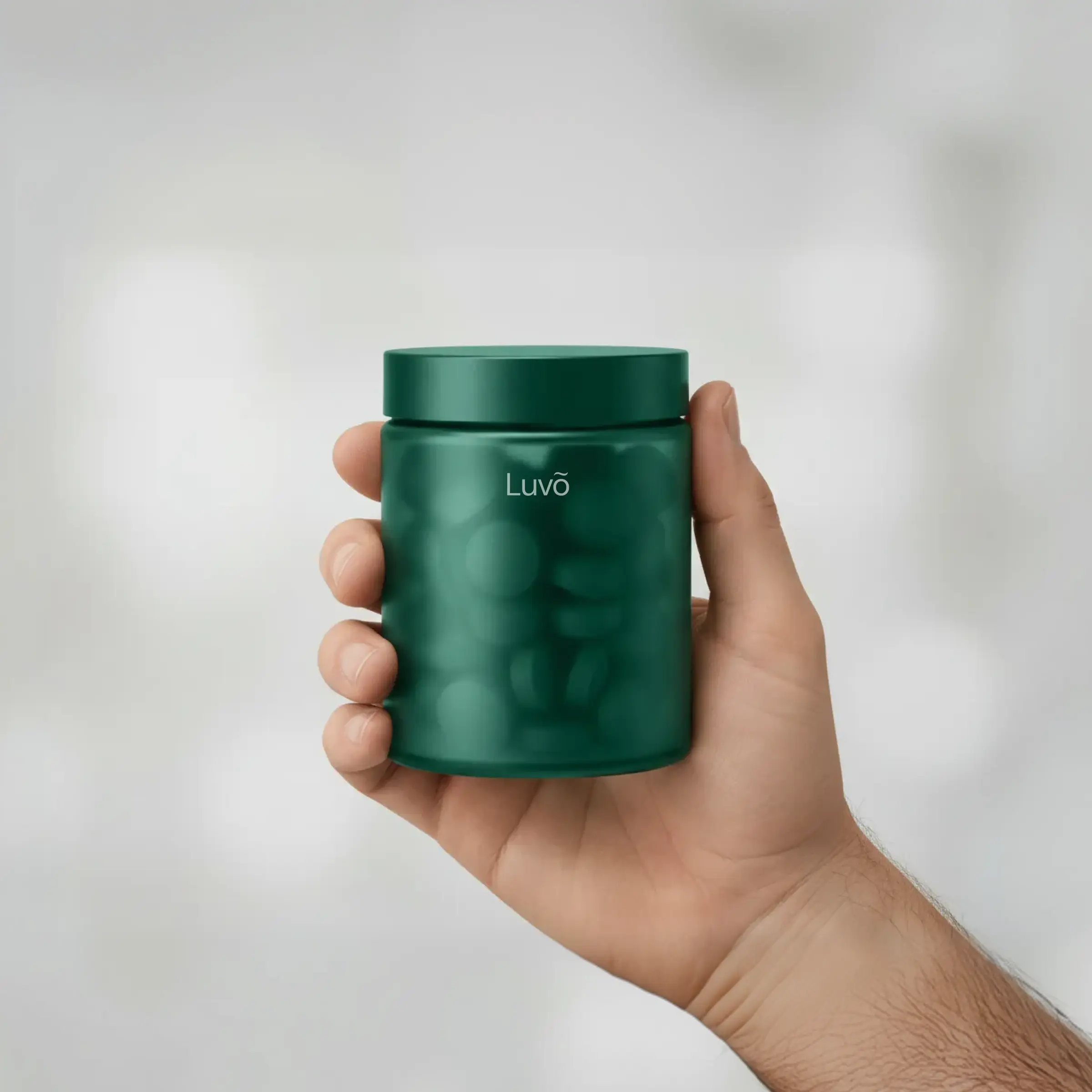 Hand holding a bottle of estradiol tablets