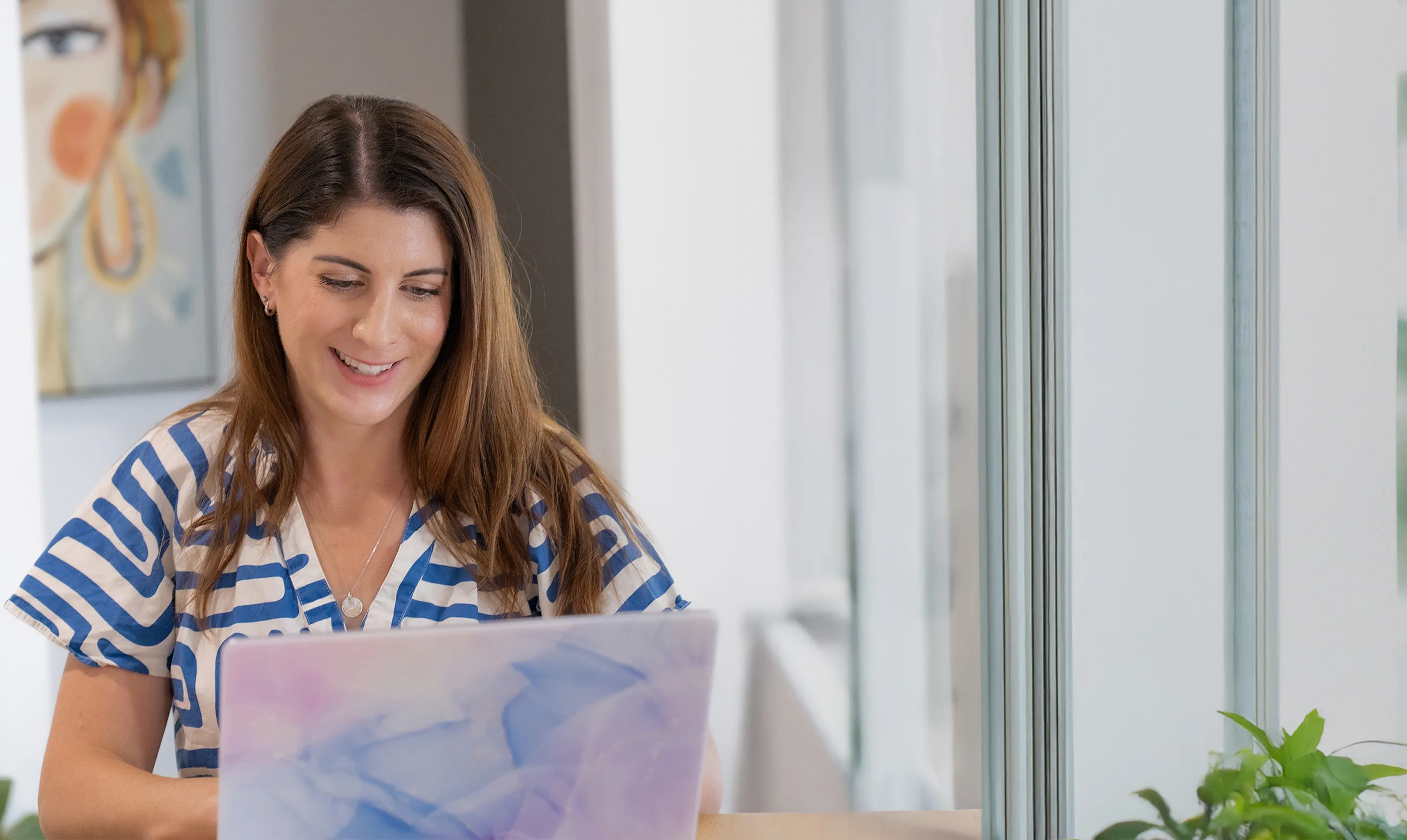 Hayley smiling while working with clients as a brand strategist in Cairns