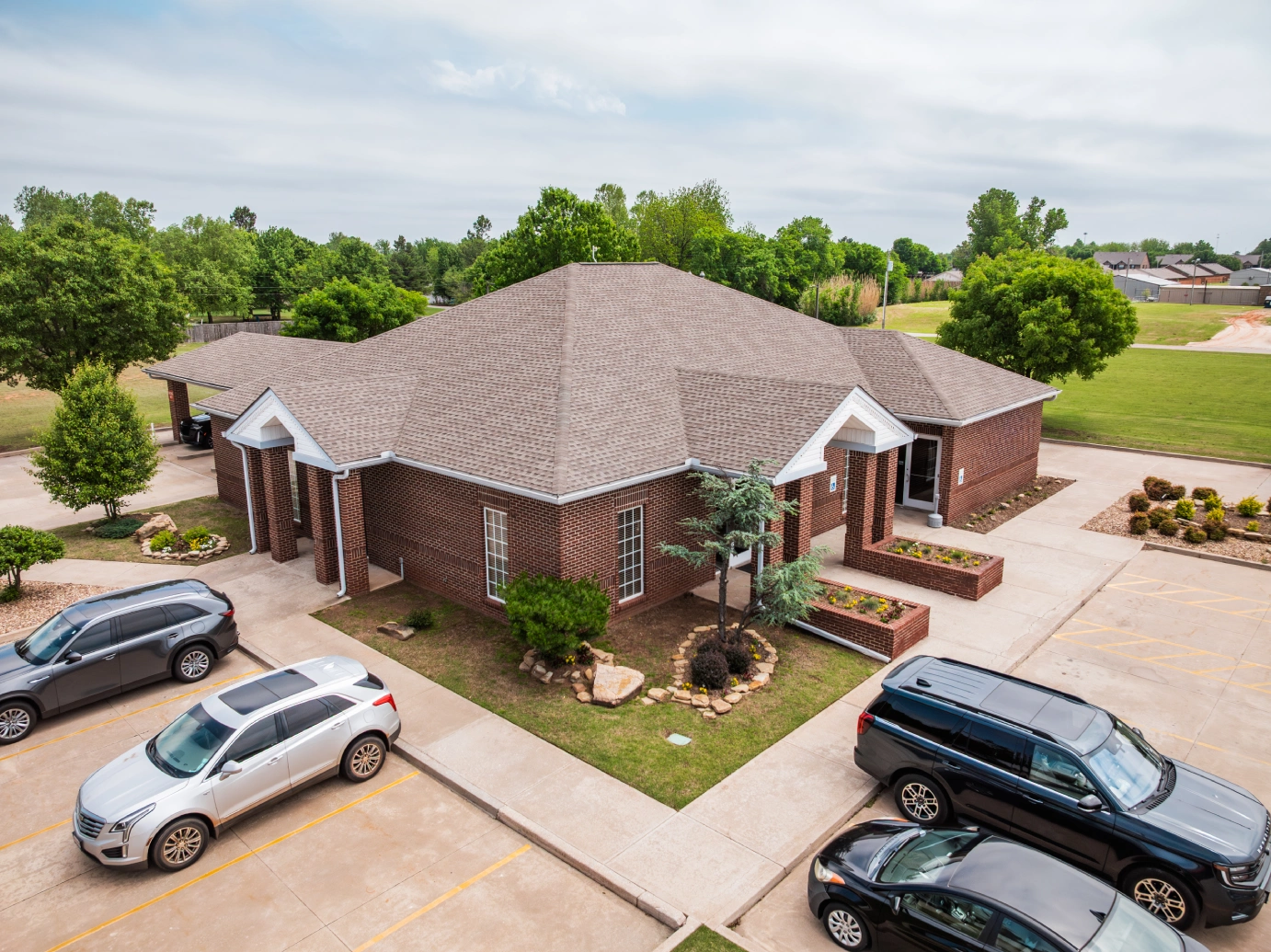 Aerial view of the brick Brooks Bank Newcastle branch and parking lot