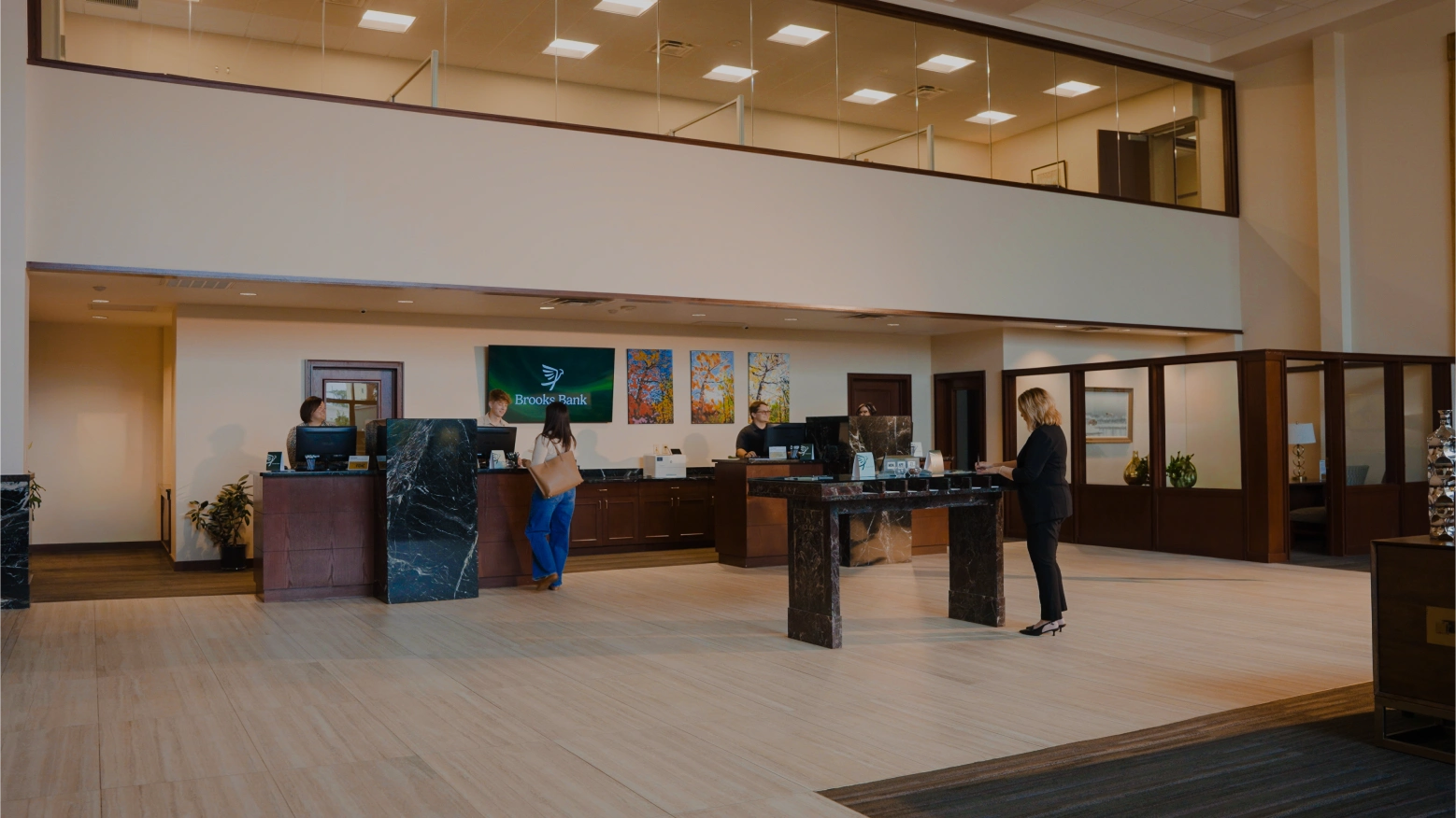 Customers at the teller counter in the Brooks Bank Chickasha lobby