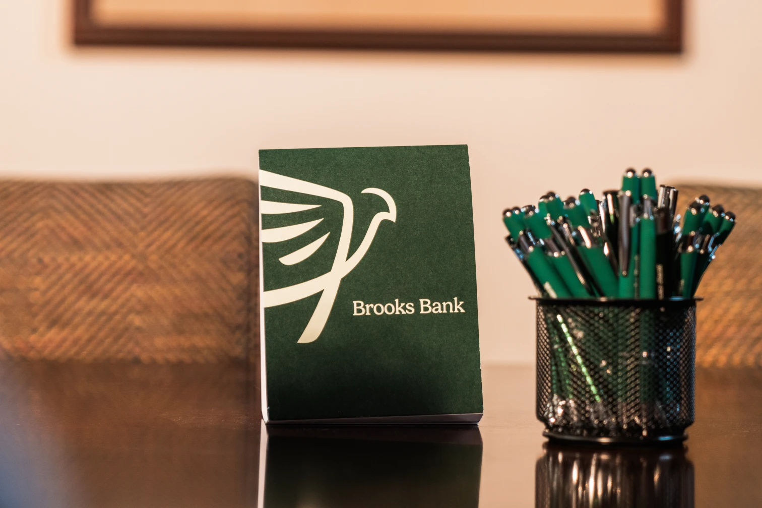 Brooks Bank tent card and branded pens on a desk