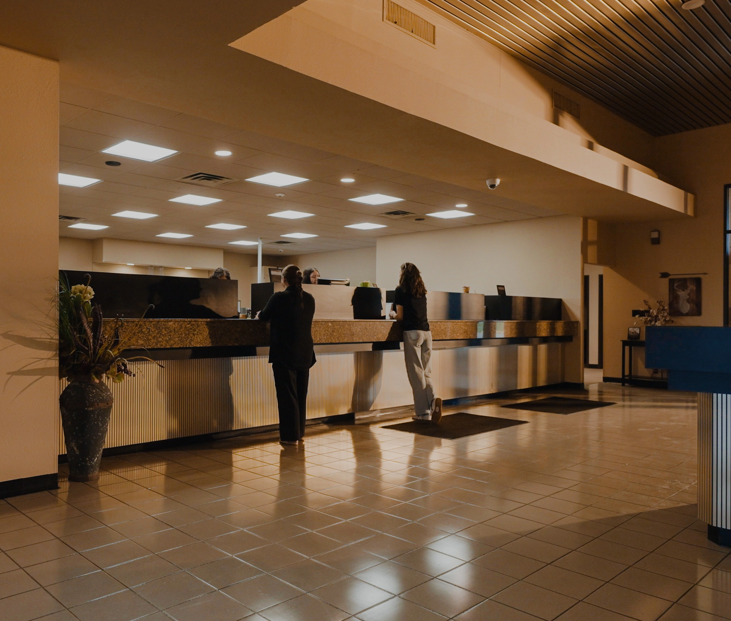 Customers at the teller line inside the Brooks Bank Minco branch