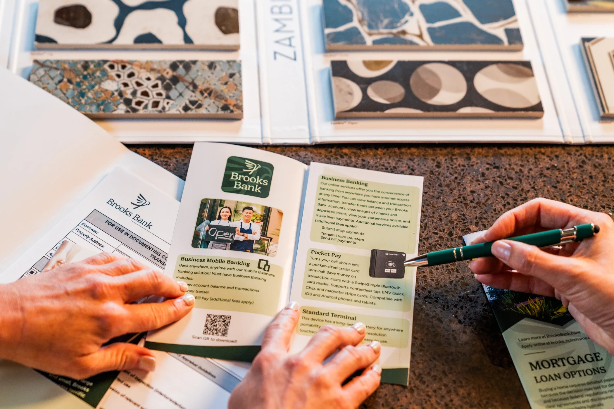Business owner reviewing a Brooks Bank business banking brochure