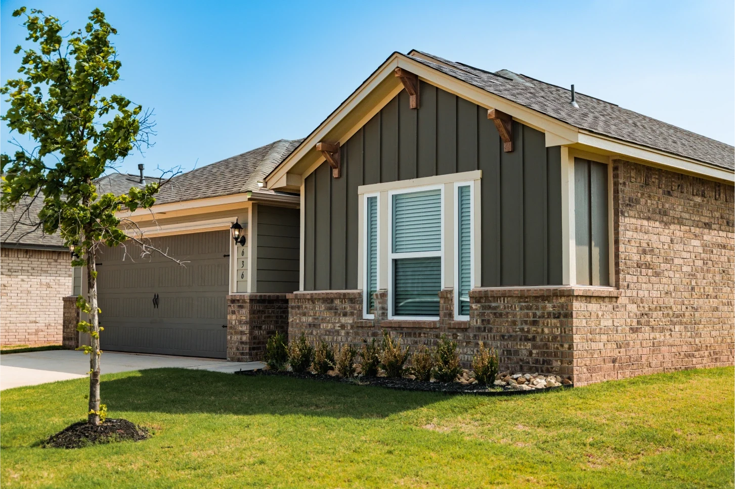 Single-story brick and board-and-batten home in an Oklahoma neighborhood