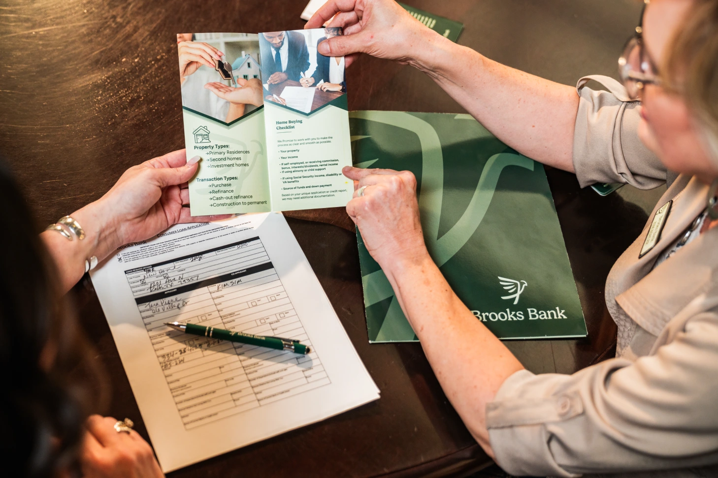 Brooks Bank lender reviewing a home buying checklist with a customer
