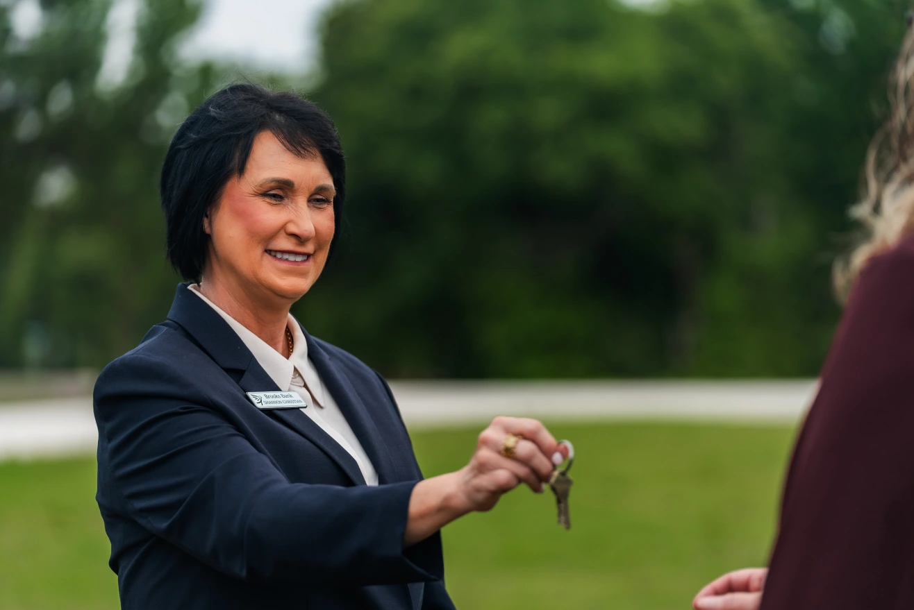 Brooks Bank lender handing house keys to a new homeowner