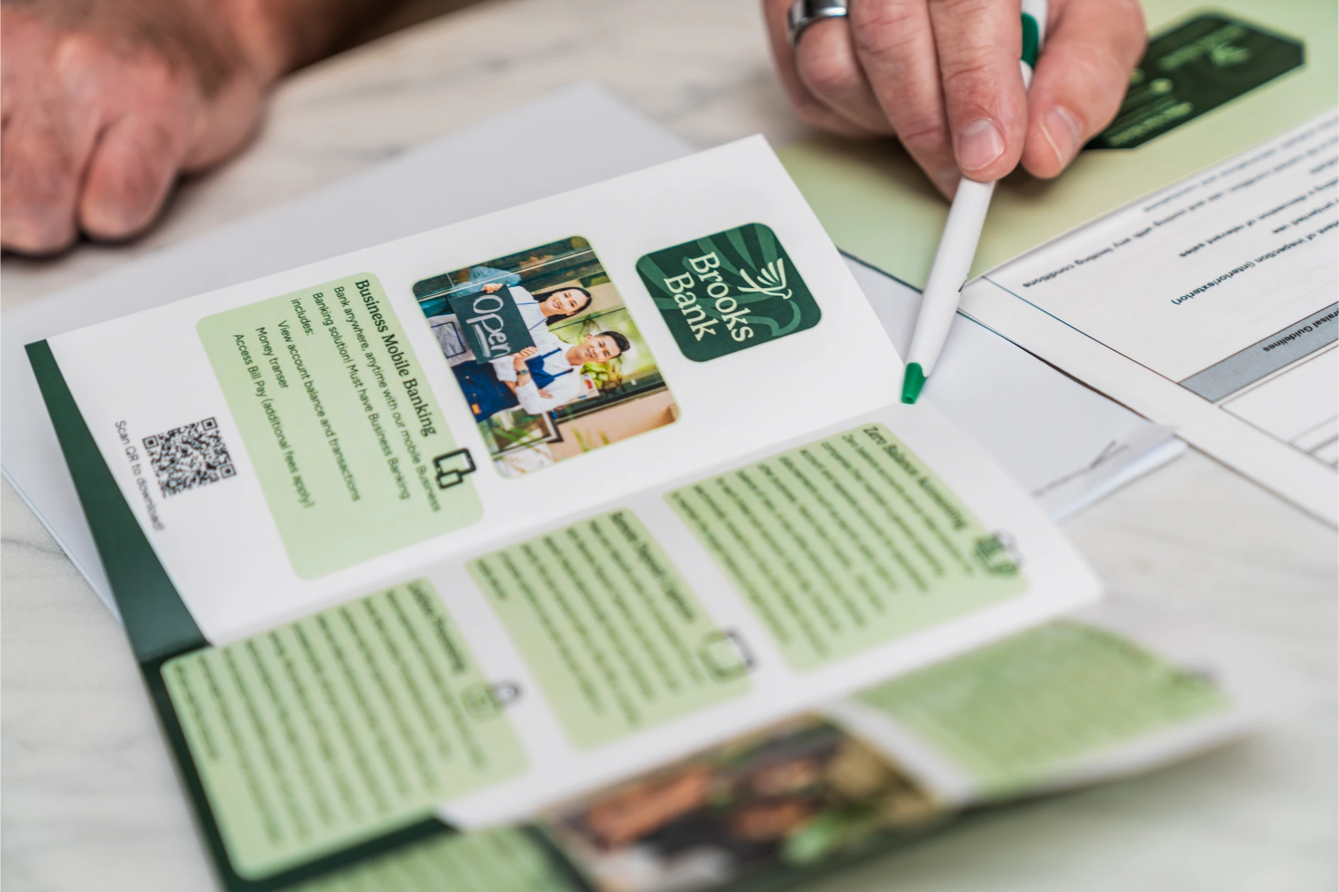 Brooks Bank mobile banking brochure open on a desk