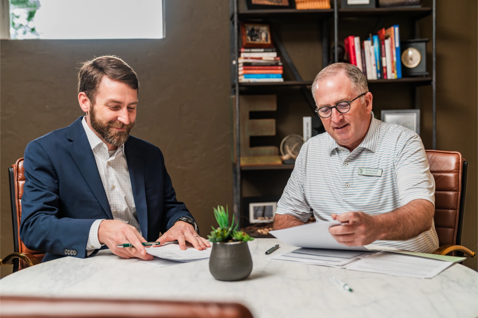 Customer reviewing account paperwork with his Brooks Bank banker