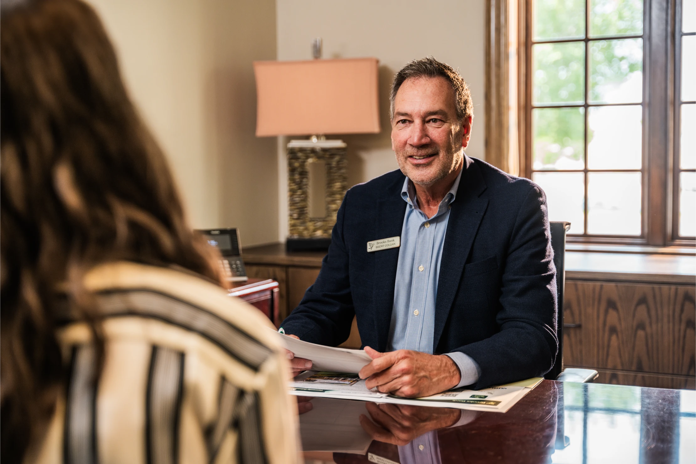 Brooks Bank loan officer meeting with a customer across his desk