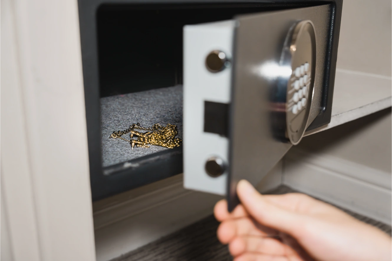Open safe deposit box with a gold necklace inside