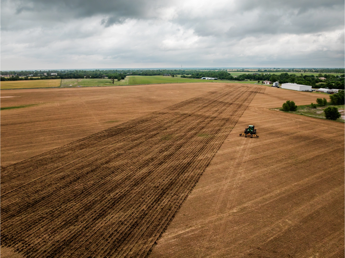 Aerial view of a tractor plowing a wide Oklahoma field