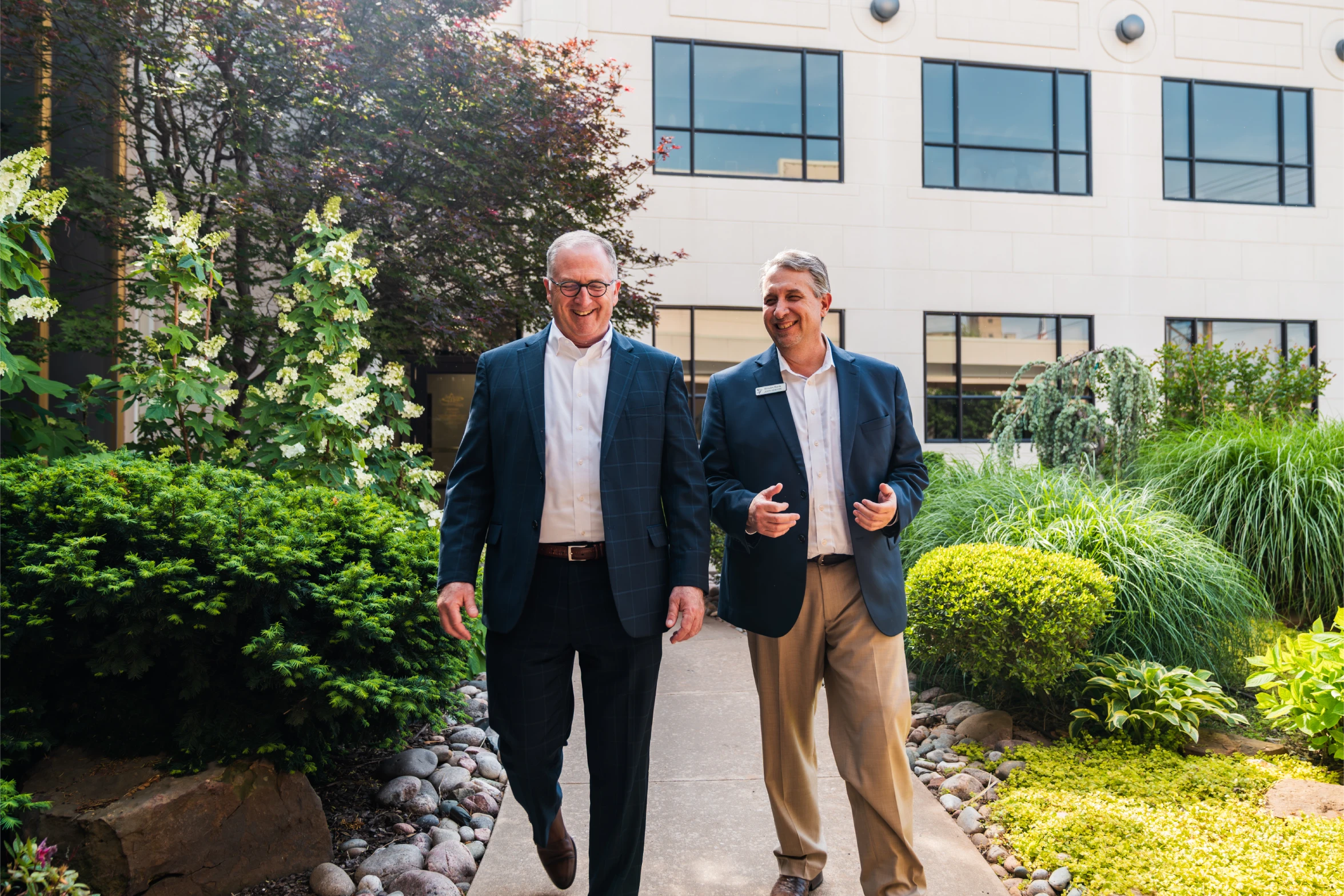 Two Brooks Bank advisors walking together outside an office building