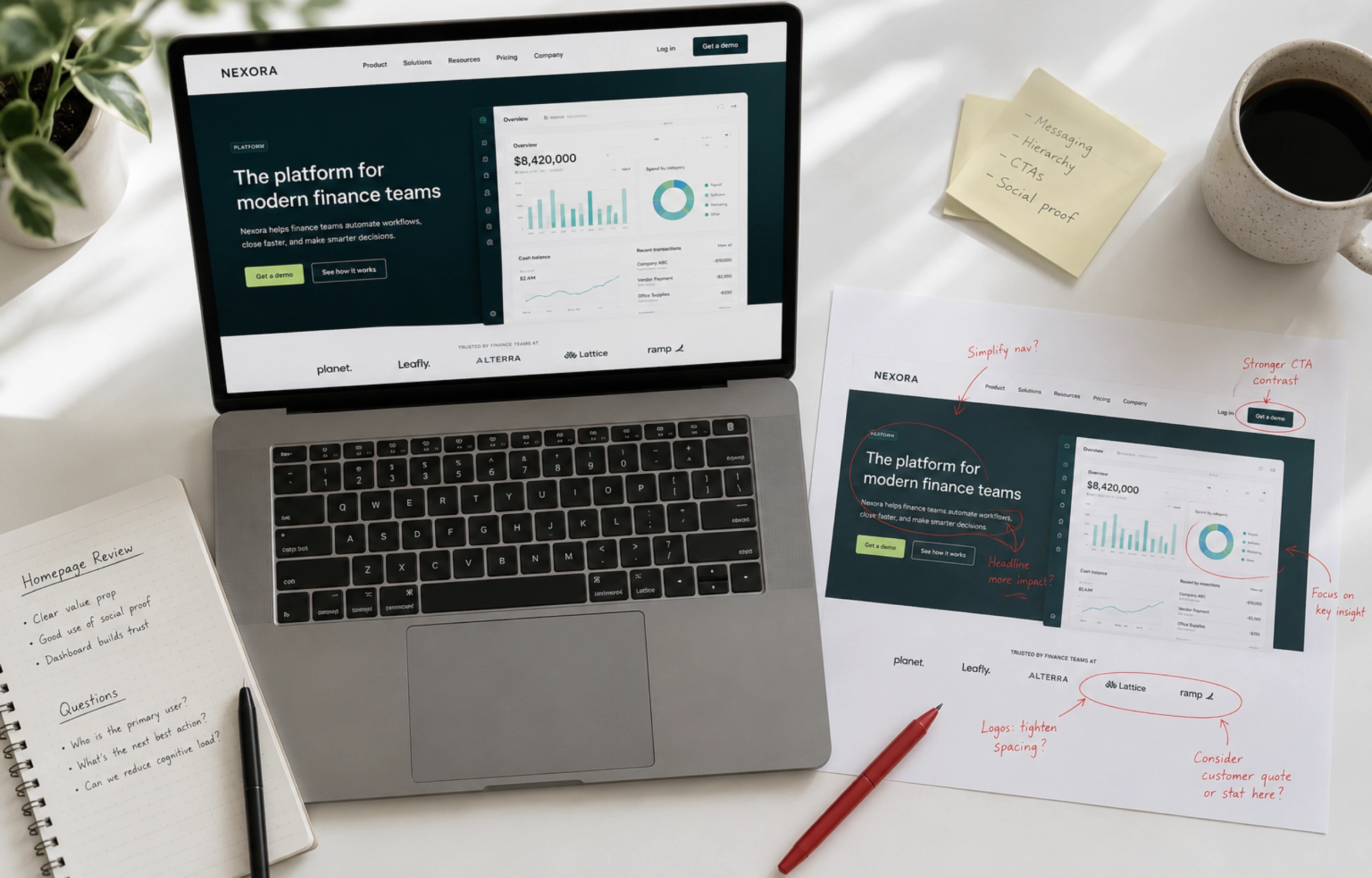 Website mistakes service businesses make: laptop showing a homepage beside a printed screenshot marked up with red pen annotations on a clean white desk.