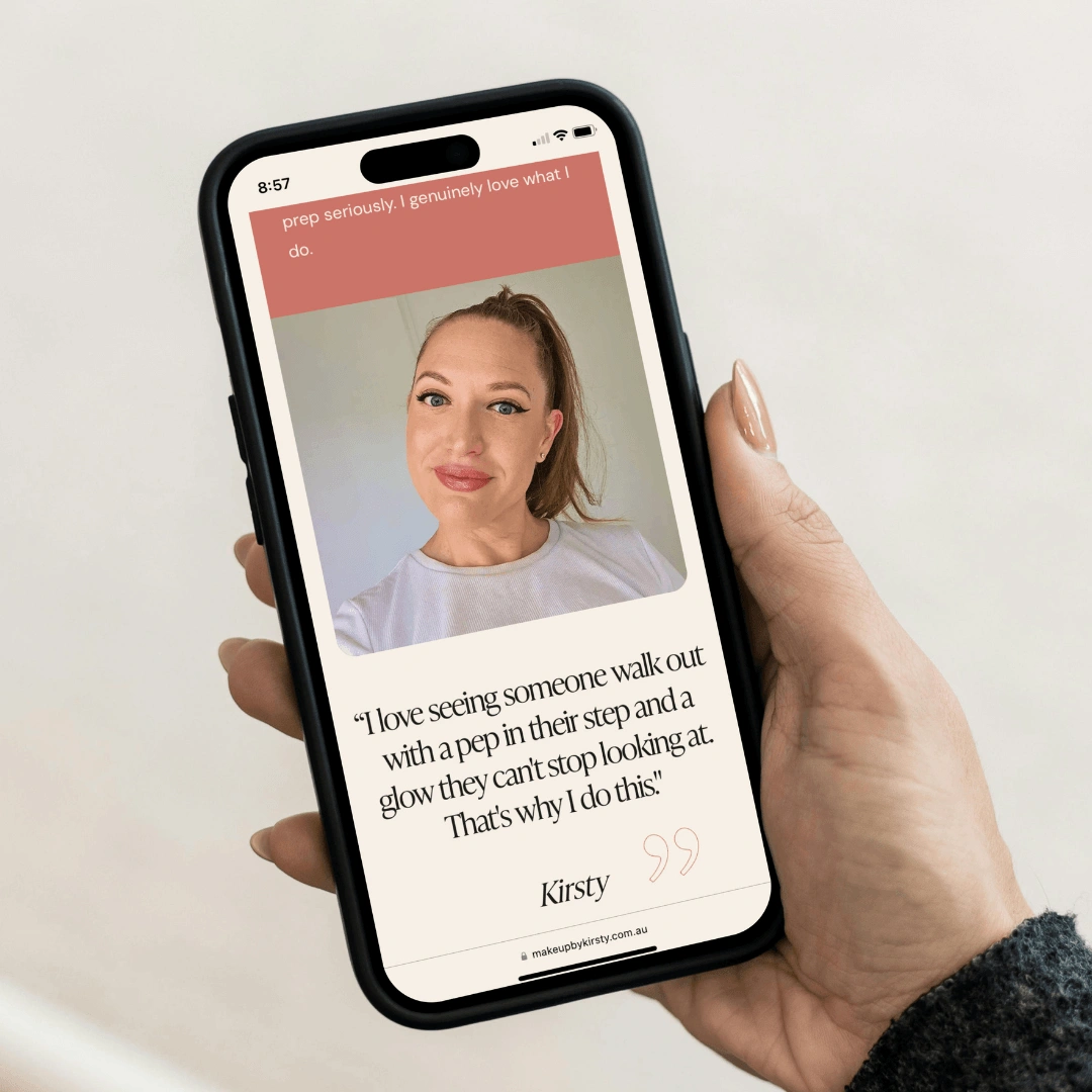 Hand holding a smartphone displaying a testimonial page on the Make Up by Kirsty website, featuring a client photo and a quote from Kirsty about her passion for makeup artistry