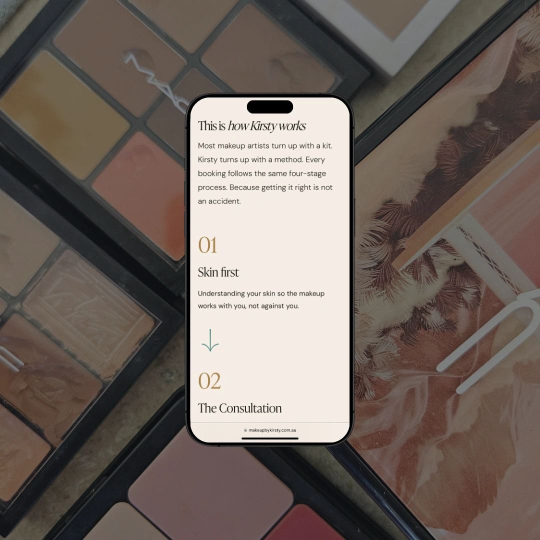 Smartphone mockup resting on eyeshadow palettes, displaying the "This is how Kirsty works" page on the Make Up by Kirsty website, showing step 01: Skin first