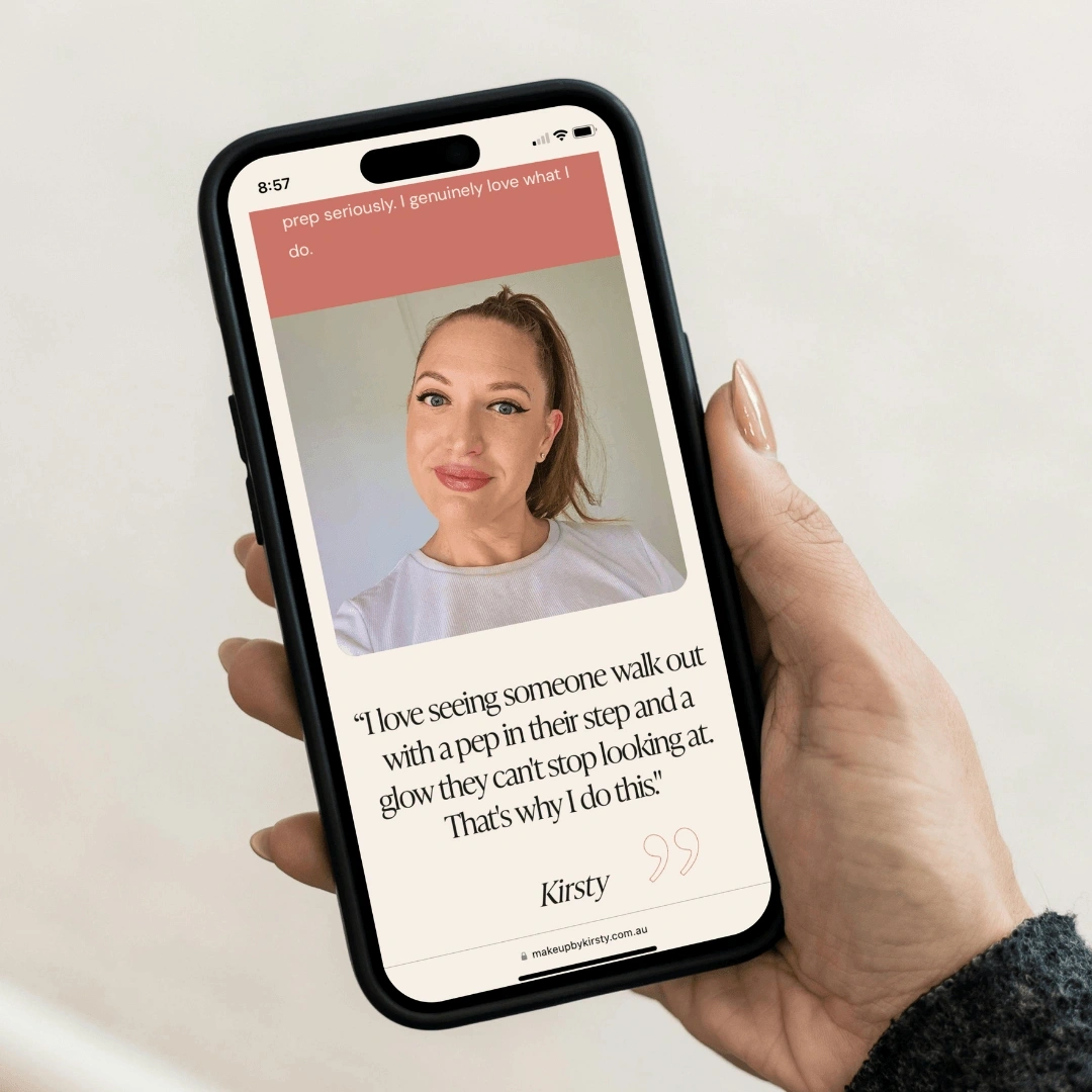 Hand holding a smartphone displaying a testimonial page on the Make Up by Kirsty website, featuring a client photo and a quote from Kirsty about her passion for makeup artistry