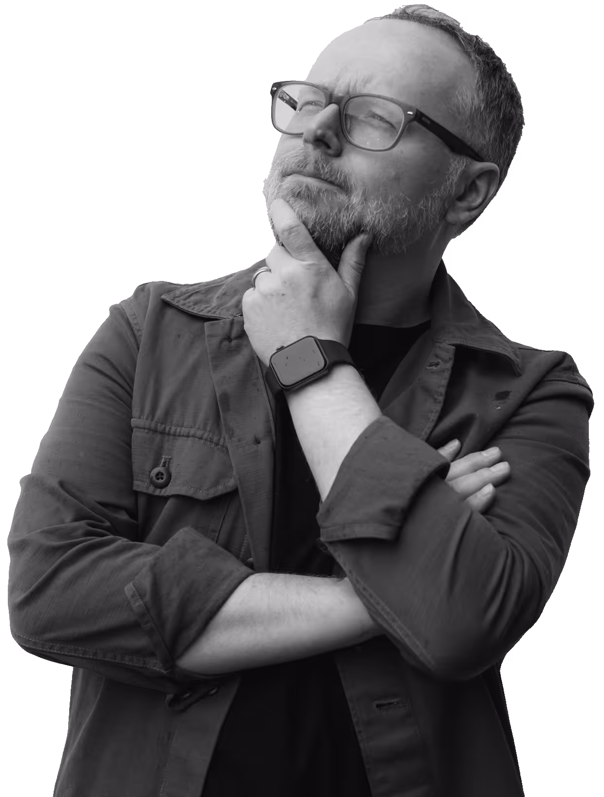 Man with glasses and beard thoughtfully looking upward with hand on chin, wearing a jacket and smartwatch.