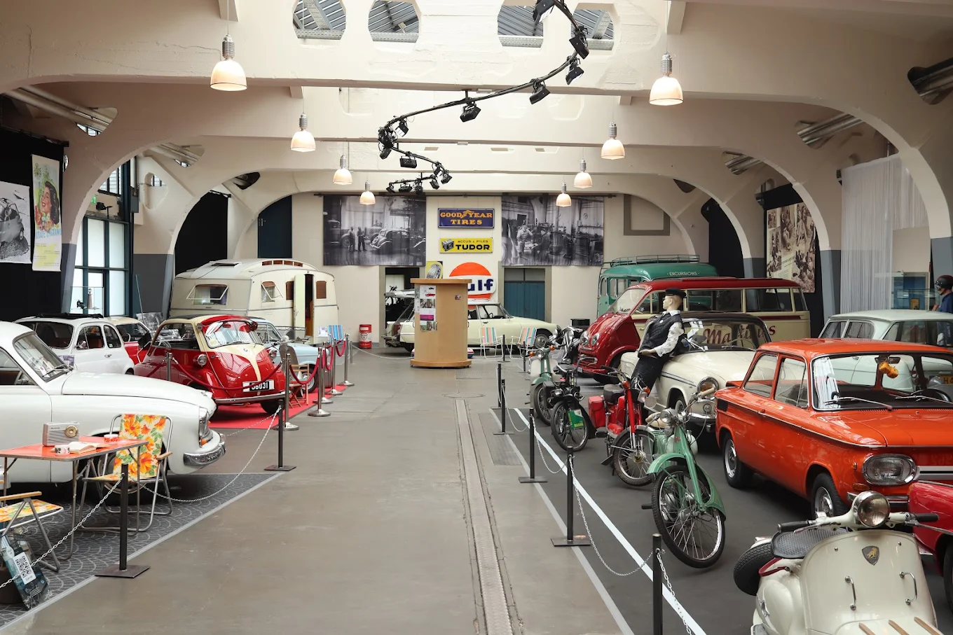 Classic cars and motorcycles displayed inside the National Museum for Vehicles in Diekirch