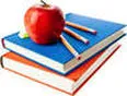 Red apple resting on stacked blue and red books with colored pencils beside the apple.