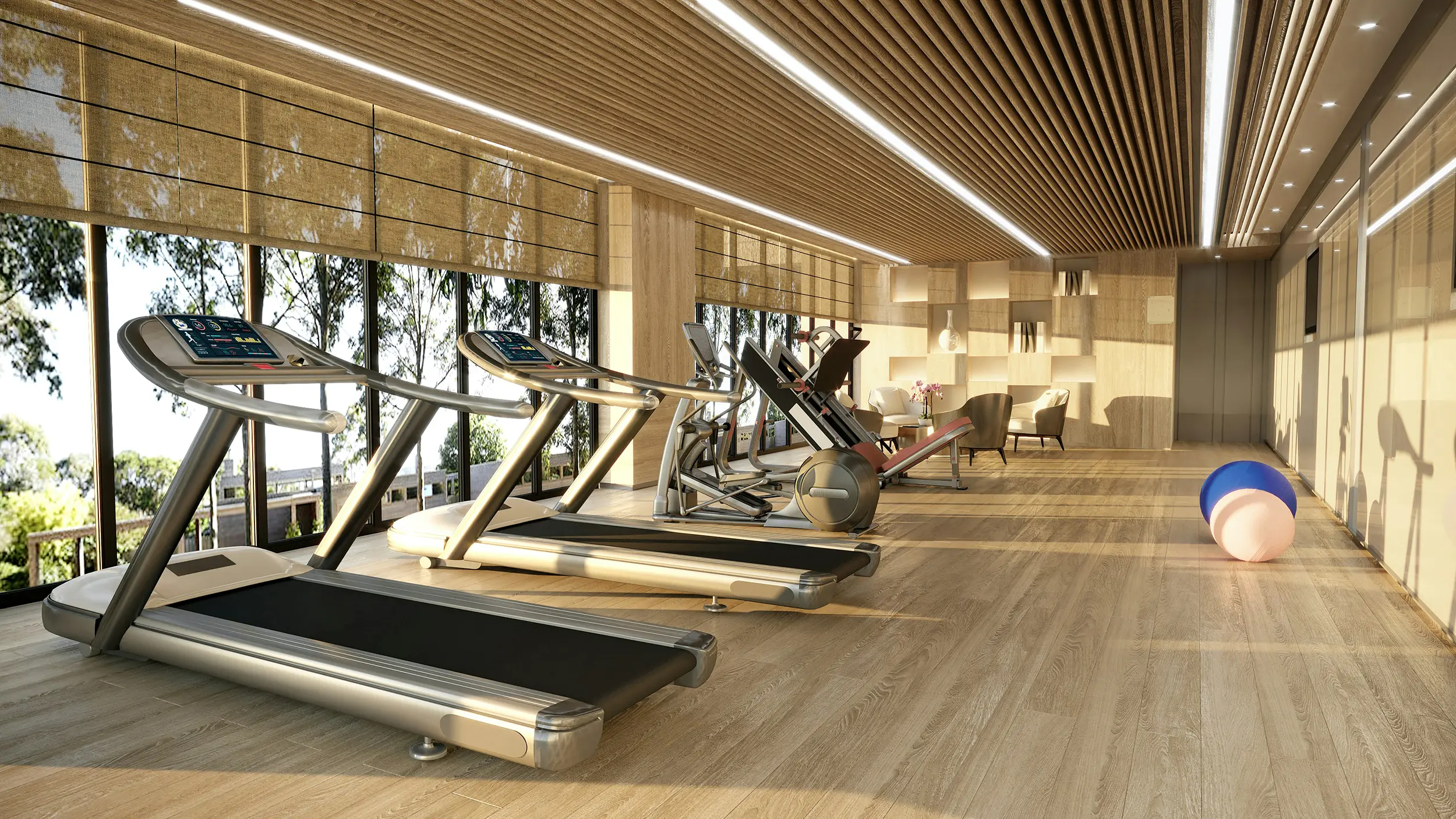 Modern gym with treadmills, exercise equipment, seating area, and large windows with natural light.