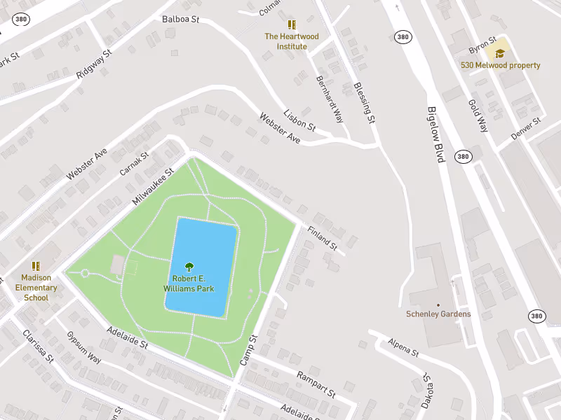 Map showing Robert E. Williams Park surrounded by streets including Milwaukee St, Camp St, Adelaide St, and Finland St, with nearby landmarks Madison Elementary School, The Heartwood Institute, and Schenley Gardens.