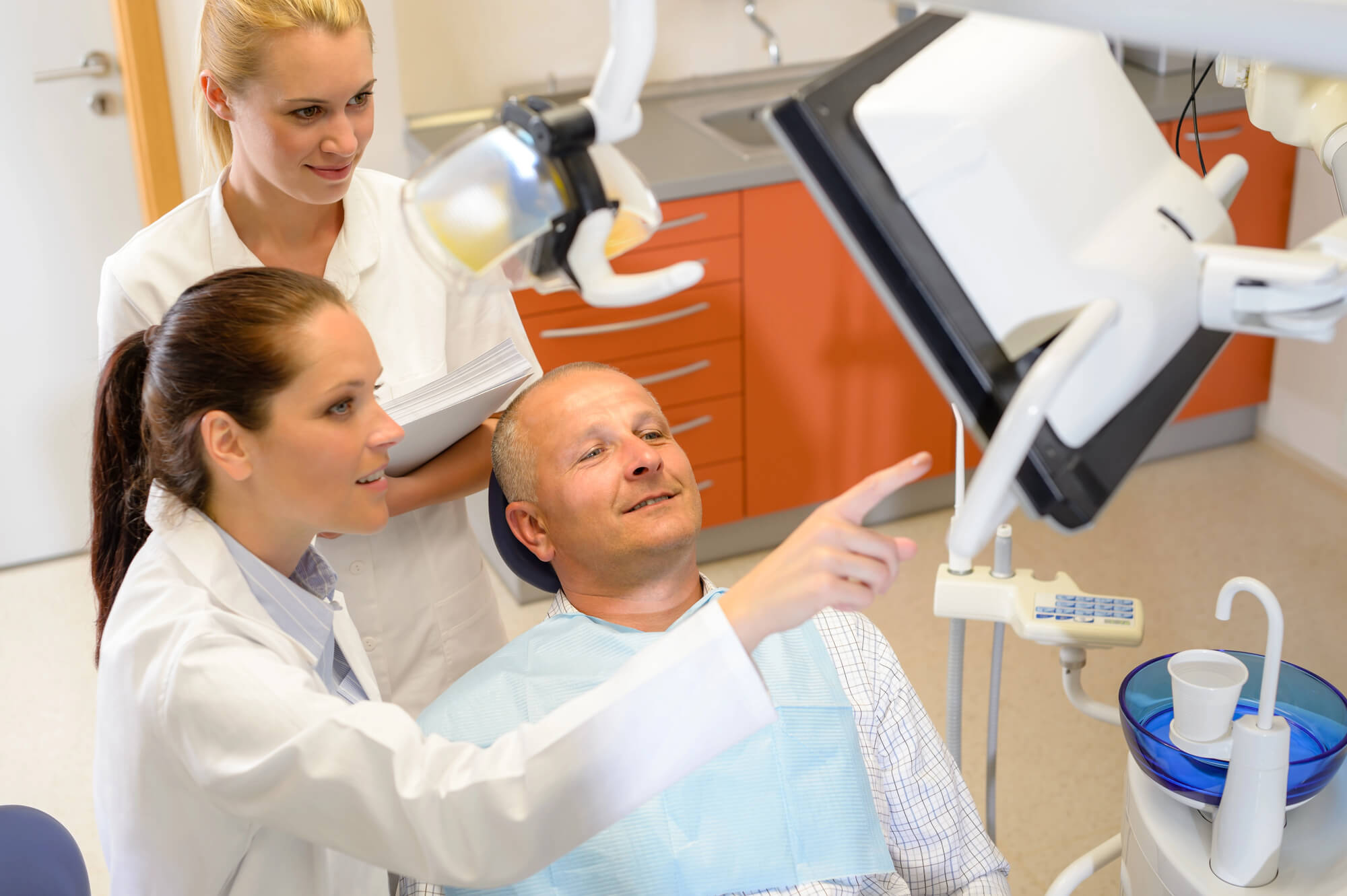 dentist showing patient metal free dental implants Orlando