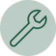 Wrench icon inside a dark green circle representing tools or settings.