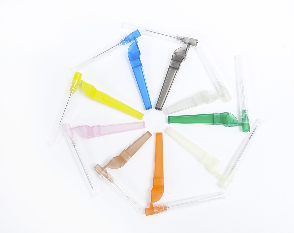 Assortment of IV catheters arranged in a circle, featuring multiple colors including blue, yellow, and green.