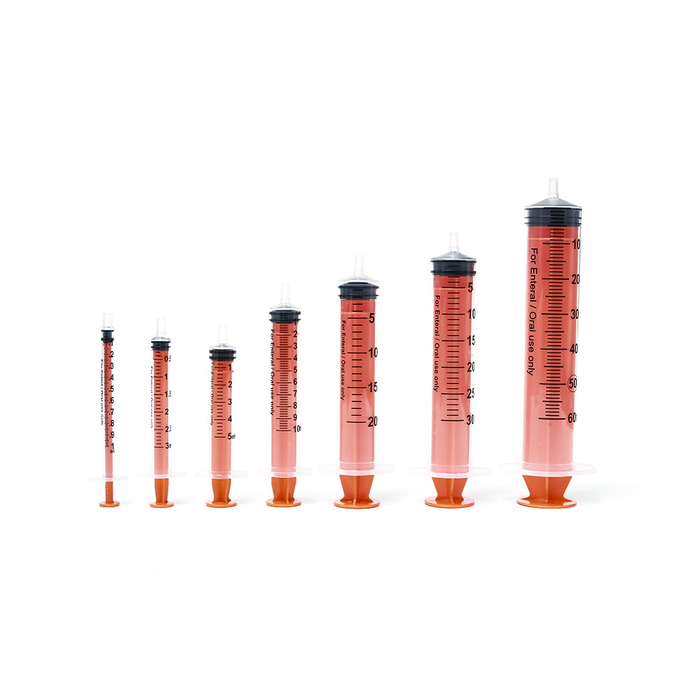 Seven different sized syringes in a row, filled with pink fluid. Orange base and black plunger.