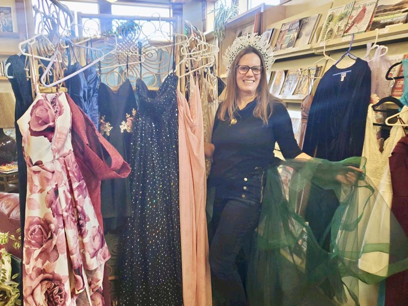 Cheyenne Warner-Bennion with some of the dresses that have been donated to Project PromPhoto credit: Camille Collings.