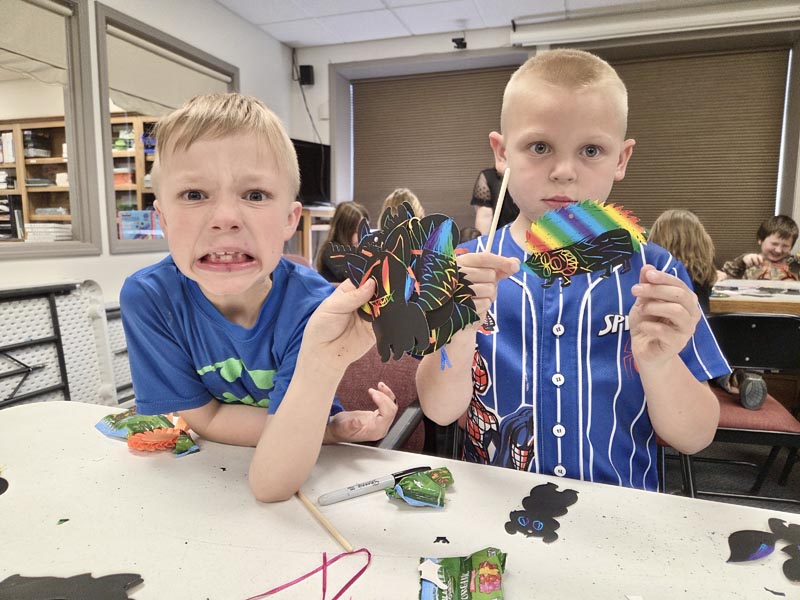 Enthusiastic boys show off their craft creations at Meadows Valley Library.Photo credit: Rachel Reynaga.