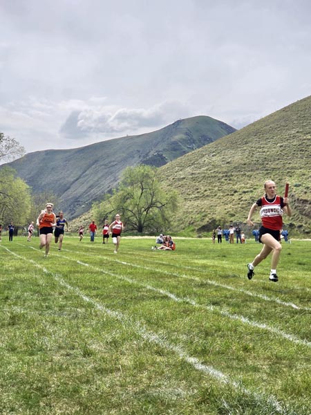From left: Tri-Valley’s Lilly Juica, Council’s Quiynn Piercy and Kim Mendenhall compete in the 4X100 relay. Council’s A and B teams took first and second with Meadows Valley taking fourth in the event. Photo credit: Rachel Reynaga.
