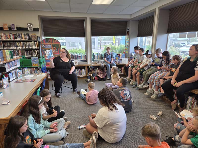 Audrey Crogh reads to children at the Meadows Valley Library. Photo credit: Rachel Reynaga.