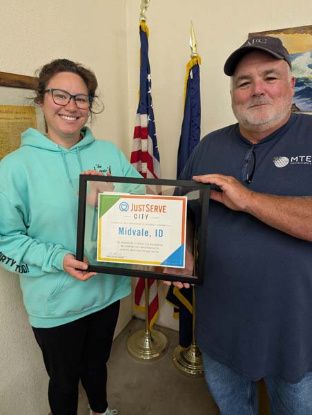 Midvale City Clerk Mariah Johnson and Mayor Brian Graham receiving the JustServe City designation award Monday, June 29, 2026. Photo credit: Don Dopf.