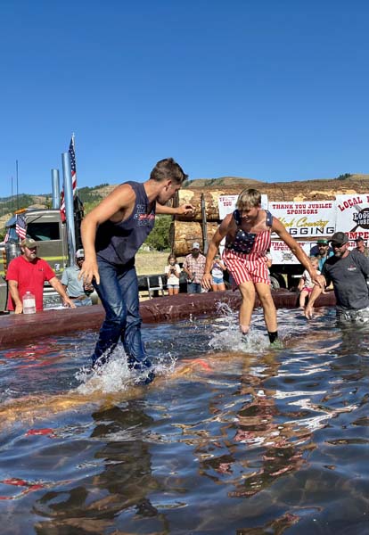 Clayton Costa, left, and Ayden Heinemeyer cool off while log birling at the Council Loggers Jubilee on July 4. Clayton won the event and took home $300. Photo credit: Trina Jokela.