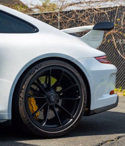 An artistic shot of a 991.2 Porsche 911 GT3 painted in Carrara White with Porsche Carbon Ceramic Brakes 