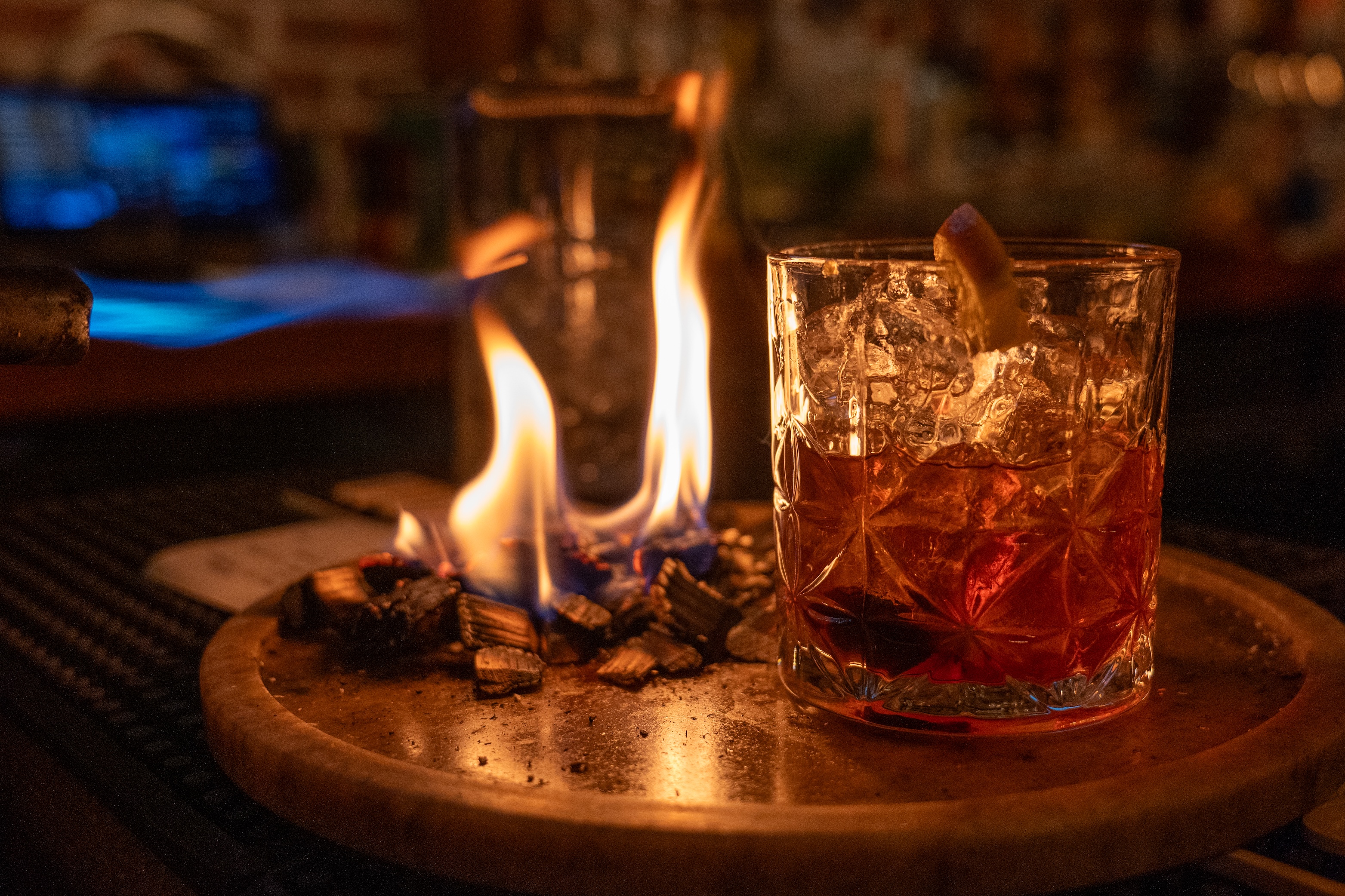Breaded chicken breast topped with white sauce and microgreens, served with mashed potatoes and broccolini on a blue plate.